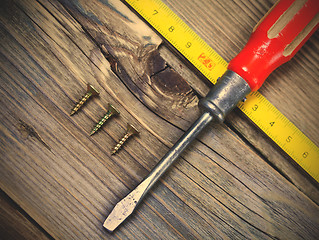 Image showing Vintage screwdriver, screws and measuring lenght