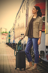 Image showing beautiful middle-aged woman with luggage rides in retro trip