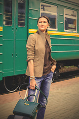 Image showing woman with luggage returned from a retro travel