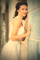 Image showing woman in a white dress near the old stone wall