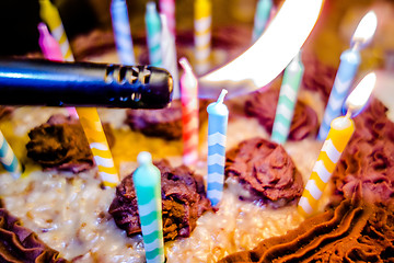 Image showing lighting Colorful candles on birthday cake  