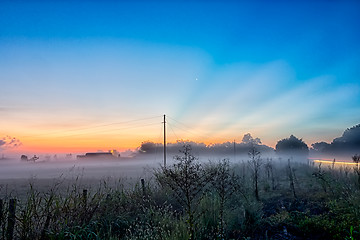 Image showing early sunrise over foggy farm landscape in rock hill south carol