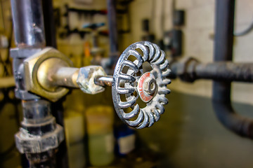 Image showing various old boiler room pipe valves