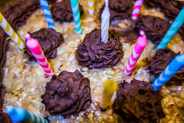 Image showing lighting Colorful candles on birthday cake  