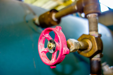 Image showing various old boiler room pipe valves