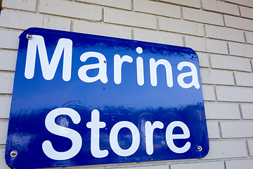 Image showing boat marina store sign on brick masonry wall