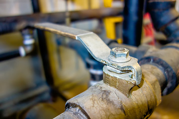 Image showing various old boiler room pipe valves