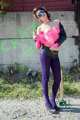 Image showing Pretty girl in pink net blouse with sledge hammer