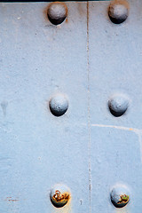Image showing blue   handle in  rusty  brass nail and light
