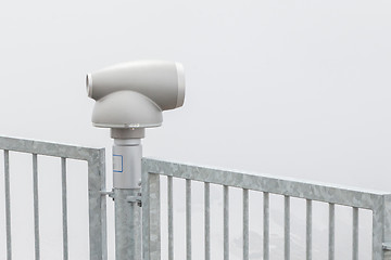 Image showing Binoculars against the grey sky