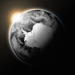 Image showing Sun over Antarctica on dark planet Earth