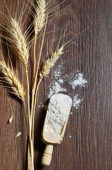 Image showing Wood spoons with wheat flour