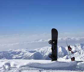 Image showing Two snowboards in snow near off-piste slope in sun day