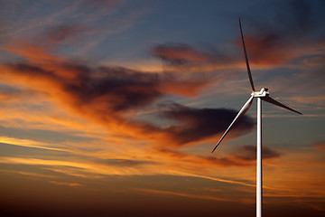 Image showing Wind turbine and sunset sky 