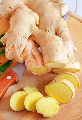 Image showing Fresh ginger and knife on the wooden board