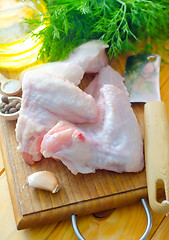 Image showing Raw chicken on wooden board, Chicken Wings