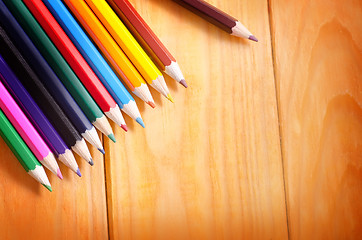 Image showing color pencils on wooden background, school supplies