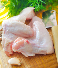 Image showing Raw chicken on wooden board, Chicken Wings