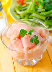 Image showing raw chicken and raw vegetables on wooden table