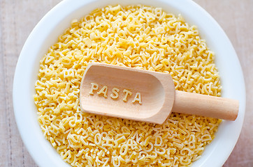 Image showing assortment of raw pasta and wheat on wooden background