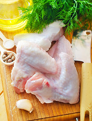 Image showing Raw chicken on wooden board, Chicken Wings