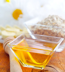 Image showing Honey in the glass bowl on the wooden table