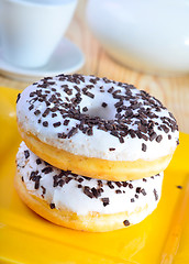 Image showing Delicious doughnuts on the yellow plate, donuts with chocolate