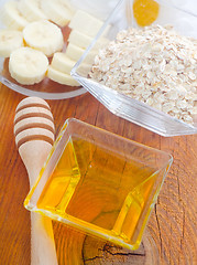 Image showing Honey in the glass bowl on the wooden table