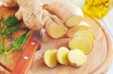 Image showing Fresh ginger and knife on the wooden board