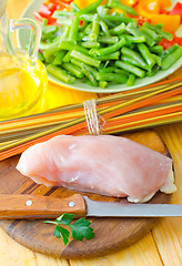 Image showing Raw chicken on the wooden board, raw chicken and raw pasta