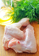 Image showing Raw chicken on wooden board, Chicken Wings