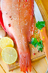 Image showing raw fish with aroma spice on wooden background