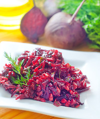 Image showing Fresh salad with beet and walnuts on white plate