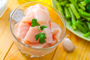 Image showing raw chicken and raw vegetables on wooden table