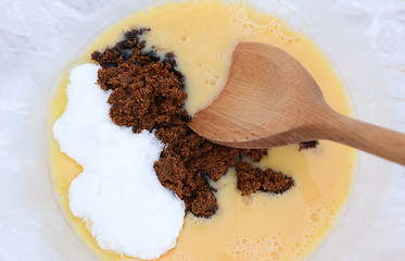 Image showing Mixing muscovado and caster sugar into beaten eggs