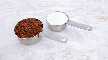 Image showing Measuring cups of muscovado and caster sugar