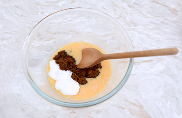 Image showing Stirring caster and muscovado sugar into beaten egg