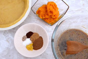 Image showing Making pumpkin pie - pastry crust, pumpkin, spices and filling
