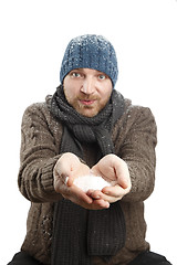 Image showing Portrait of an attractive man with snow in his hands