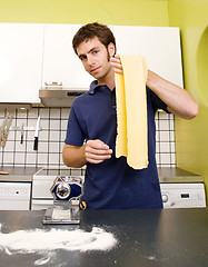 Image showing Happy Male Making Pasta