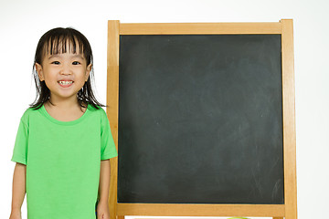 Image showing Chinese little girl with blank blackboard