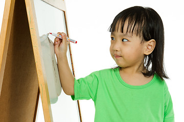 Image showing Chinese little girl writing on whiteboard