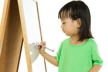 Image showing Chinese little girl writing on whiteboard