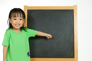 Image showing Chinese little girl with blank blackboard