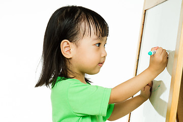 Image showing Chinese little girl writing on whiteboard