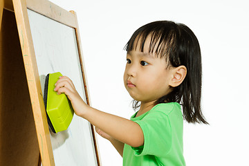 Image showing Chinese little girl writing on whiteboard