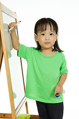 Image showing Chinese little girl writing on whiteboard