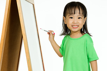 Image showing Chinese little girl writing on whiteboard