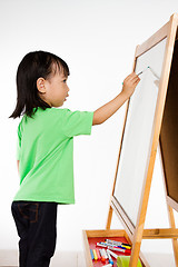 Image showing Chinese little girl writing on whiteboard