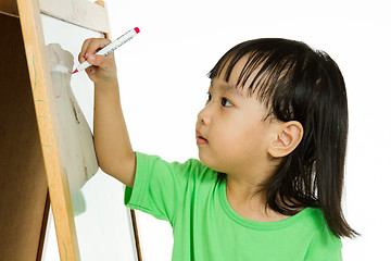 Image showing Chinese little girl writing on whiteboard